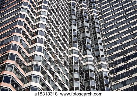 Stock Photo - USA, New York State, New York City, Low angle view on glass skyscraper. Fotosearch