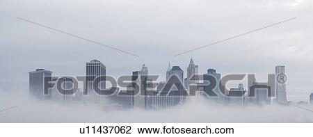 Stock Image - USA, New York State, New York City, Skyline in fog. Fotosearch