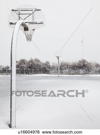 Stock Photo - USA, New York State, Rockaway Beach, basketball hoop in winter. Fotosearch