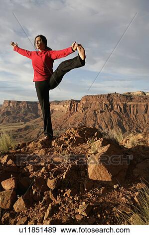 USA, Utah, Canyonlands National Park, woman stretching on rock View Large Photo Image Stock Photo - USA, Utah, Canyonlands National Park, woman stretching on rock. Fotosearch