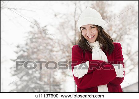 Stock Image - USA, Utah, Lehi, Portrait of young woman shivering in snow. Fotosearch