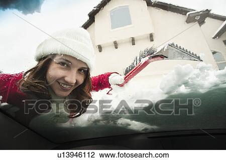 USA, Utah, Lehi, Portrait of young woman scraping snow from car windscreen View Large Photo Image Stock Image - USA, Utah, Lehi, Portrait of young woman scraping snow from car windscreen. Fotosearch