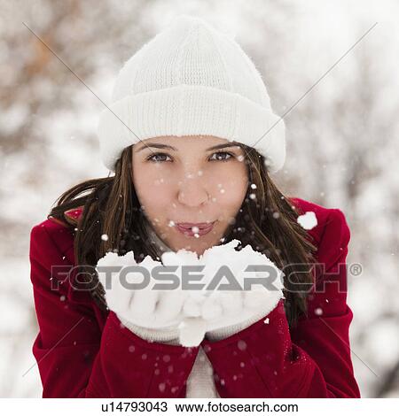 USA, Utah, Lehi, Portrait of young woman blowing snow View Large Photo Image Stock Image - USA, Utah, Lehi, Portrait of young woman blowing snow. Fotosearch