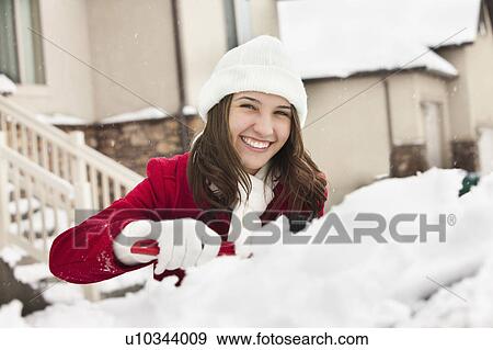 USA, Utah, Lehi, Portrait of young woman scraping snow from car View Large Photo Image Stock Photo - USA, Utah, Lehi, Portrait of young woman scraping snow from car. Fotosearch