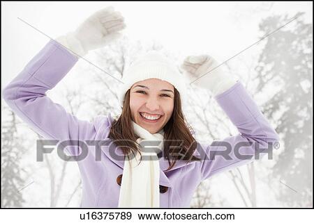 Stock Photo - USA, Utah, Lehi, Portrait of young woman wearing winter coat outdoors. Fotosearch