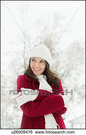 Stock Photograph - USA, Utah, Lehi, Young woman shivering in snow. Fotosearch