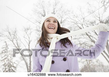 Stock Photo - USA, Utah, Lehi, Young woman wearing winter coat outdoors. Fotosearch