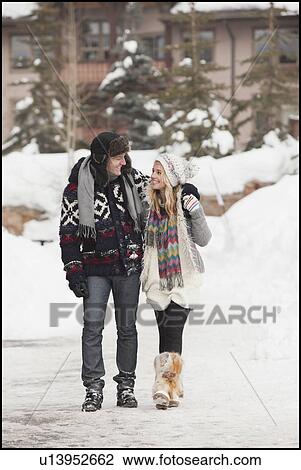 USA, Utah, Salt Lake City, couple walking in snowy village View Large Photo Image Stock Image - USA, Utah, Salt Lake City, couple walking in snowy village. Fotosearch
