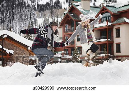 USA, Utah, Salt Lake City, couple walking through snow in resort View Large Photo Image Stock Photo - USA, Utah, Salt Lake City, couple walking through snow in resort. Fotosearch