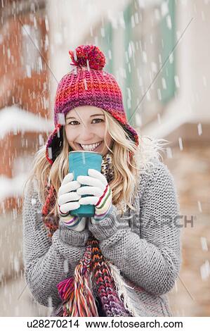 USA, Utah, Salt Lake City, portrait of young woman in winter clothing drinking View Large Photo Image Picture - USA, Utah, Salt Lake City, portrait of young woman in winter clothing drinking. Fotosearch