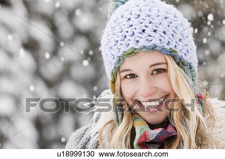 Stock Image - USA, Utah, Salt Lake City, portrait of young woman in winter clothing. Fotosearch
