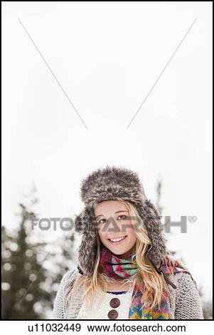 Stock Photo - USA, Utah, Salt Lake City, portrait of young woman in winter clothing. Fotosearch