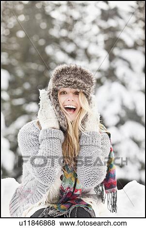 Stock Photo - USA, Utah, Salt Lake City, portrait of young woman in winter clothing. Fotosearch