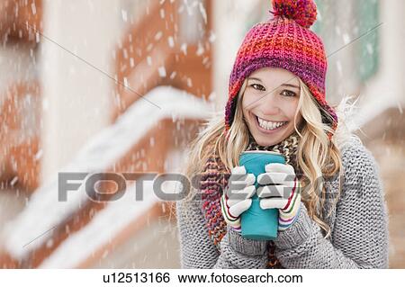 USA, Utah, Salt Lake City, portrait of young woman in winter clothing drinking View Large Photo Image Stock Photograph - USA, Utah, Salt Lake City, portrait of young woman in winter clothing drinking. Fotosearch