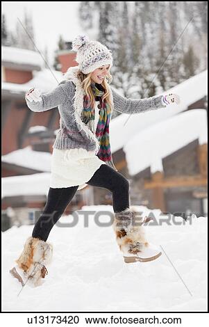 USA, Utah, Salt Lake City, young woman walking through snow in resort View Large Photo Image Stock Image - USA, Utah, Salt Lake City, young woman walking through snow in resort. Fotosearch