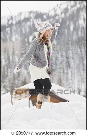 USA, Utah, Salt Lake City, young woman walking through snow in resort View Large Photo Image Stock Photo - USA, Utah, Salt Lake City, young woman walking through snow in resort. Fotosearch