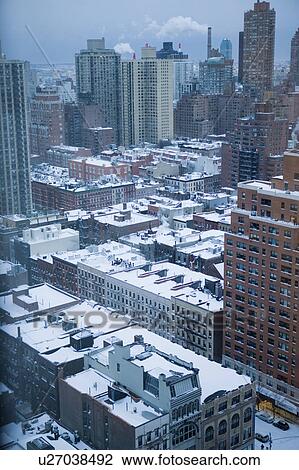 Stock Image - USA, View of New York City covered with snow . Fotosearch
