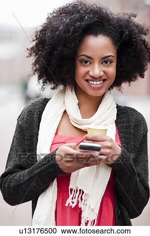 USA, Washington State, Seattle, Cheerful young woman text messaging while holding takeaway coffee View Large Photo Image Stock Image - USA, Washington State, Seattle, Cheerful young woman text messaging while holding takeaway coffee. Fotosearch