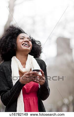 USA, Washington State, Seattle, Cheerful young woman text messaging View Large Photo Image Stock Photo - USA, Washington State, Seattle, Cheerful young woman text messaging. Fotosearch