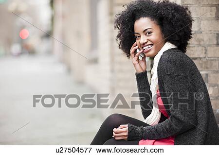 USA, Washington State, Seattle, Cheerful young woman using mobile phone View Large Photo Image Stock Photo - USA, Washington State, Seattle, Cheerful young woman using mobile phone. Fotosearch