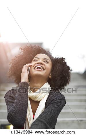 USA, Washington State, Seattle, young woman sitting on steps and talking on mobile phone View Large Photo Image Picture - USA, Washington State, Seattle, young woman sitting on steps and talking on mobile phone. Fotosearch