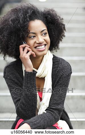 USA, Washington State, Seattle, young woman sitting on steps and talking on mobile phone View Large Photo Image Stock Image - USA, Washington State, Seattle, young woman sitting on steps and talking on mobile phone. Fotosearch