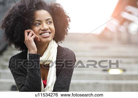 USA, Washington State, Seattle, young woman sitting on steps and talking on mobile phone View Large Photo Image Stock Photograph - USA, Washington State, Seattle, young woman sitting on steps and talking on mobile phone. Fotosearch