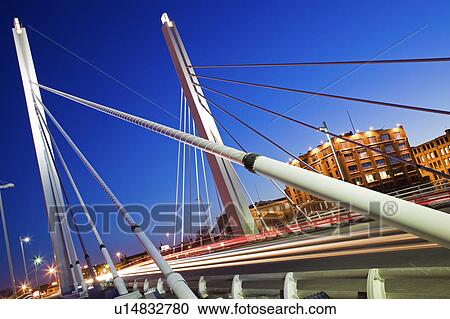 Stock Image - USA, Wisconsin, Milwaukee, suspension bridge at night. Fotosearch