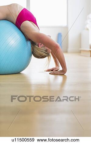 Woman exercising on fitness ball View Large Photo Image Stock Photo - Woman exercising on fitness ball. Fotosearch