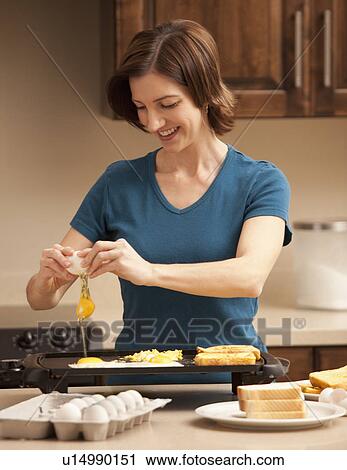 Woman preparing breakfast in kitchen View Large Photo Image Stock Image - Woman preparing breakfast in kitchen. Fotosearch