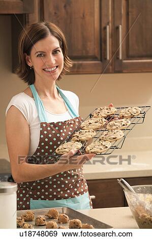 Woman preparing chocolate cookies View Large Photo Image Stock Photo - Woman preparing chocolate cookies. Fotosearch