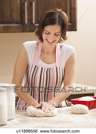 Stock Photograph - Woman preparing dough. Fotosearch