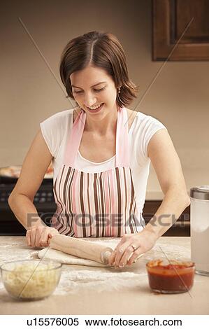 Woman preparing pizza dough in kitchen View Large Photo Image Stock Photography - Woman preparing pizza dough in kitchen. Fotosearch