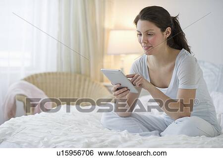 Woman sitting in bed View Large Photo Image Stock Photograph - Woman sitting in bed. Fotosearch