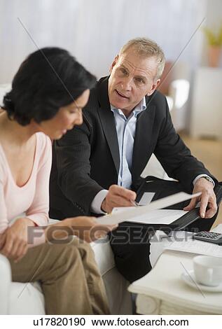 Stock Image - Woman talking to financial advisor. Fotosearch