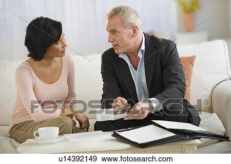 Stock Photo - Woman talking to financial advisor. Fotosearch