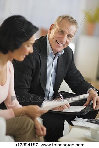 Stock Photo - Woman talking to financial advisor. Fotosearch