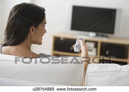 Stock Photo - Woman watching tv. Fotosearch