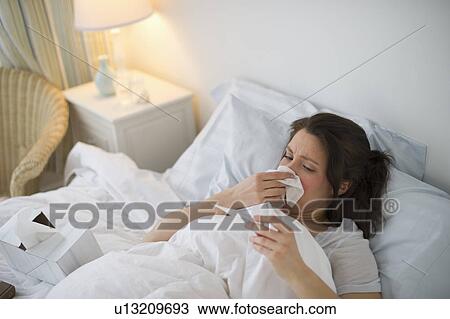 Woman with flu lying in bed View Large Photo Image Stock Image - Woman with flu lying in bed. Fotosearch