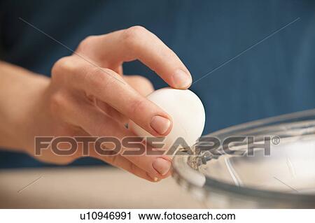 Womans hands cracking egg View Large Photo Image Stock Image - Womans hands cracking egg. Fotosearch