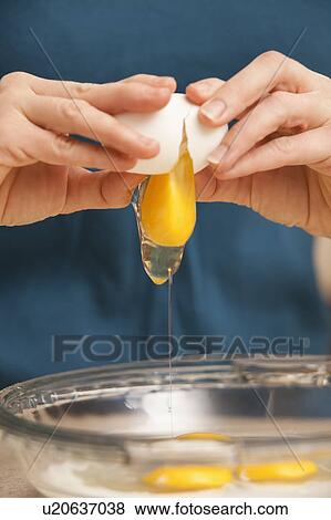 Womans hands cracking eggs View Large Photo Image Stock Photo - Womans hands cracking eggs. Fotosearch