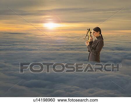 Stock Image - Women above clouds looking through sextant. Fotosearch