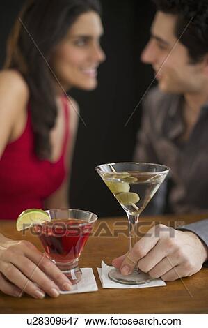 Young couple having drinks and flirting, studio shot View Large Photo Image Stock Photo - Young couple having drinks and flirting, studio shot. Fotosearch