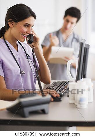 Stock Image - Young doctors during work. Fotosearch