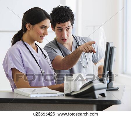 Young doctors working on computer View Large Photo Image Stock Photograph - Young doctors working on computer. Fotosearch