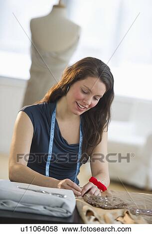 Young fashion designer at work View Large Photo Image Stock Photo - Young fashion designer at work. Fotosearch