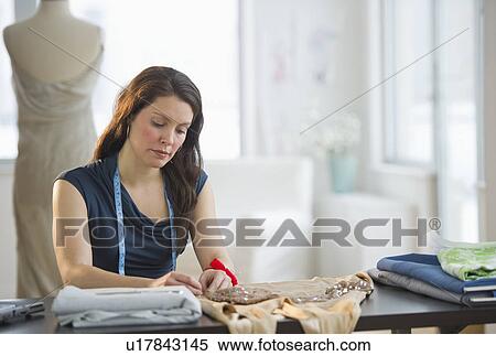 Young fashion designer at work View Large Photo Image Stock Photography - Young fashion designer at work. Fotosearch