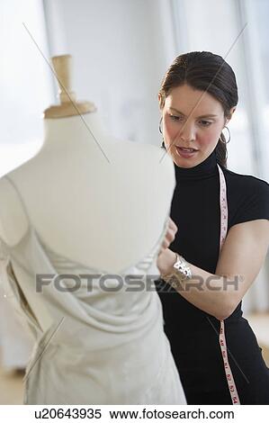 Stock Photography - Young fashion designer at work. Fotosearch
