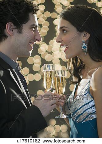 Young happy couple celebrating New Year's Eve View Large Photo Image Stock Image - Young happy couple celebrating New Year's Eve. Fotosearch