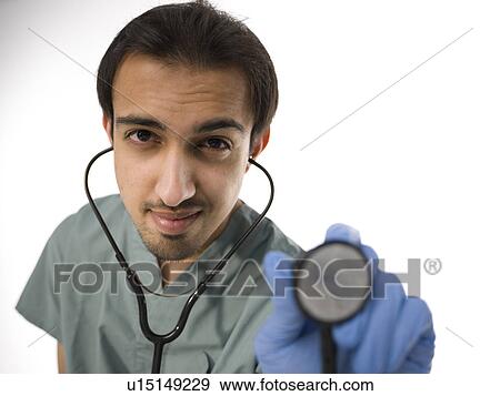 Stock Photo - Young surgeon holding stethoscope. Fotosearch